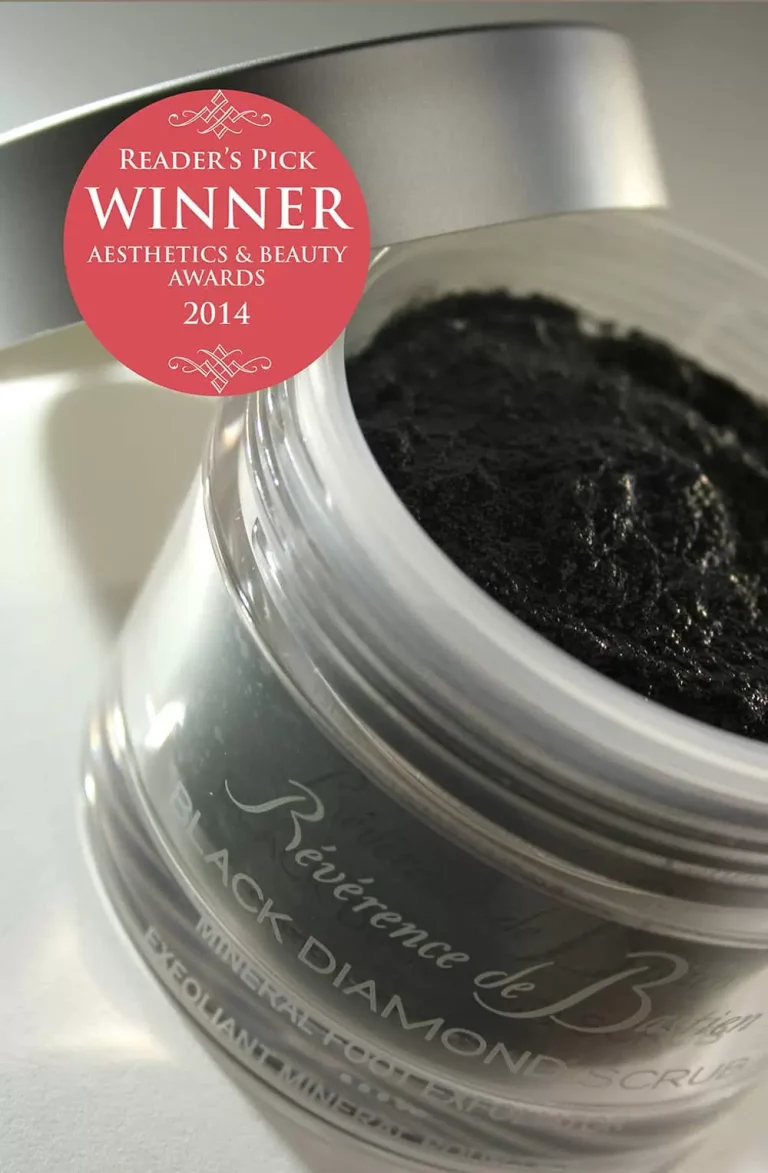 A sleek jar of Révérence de Bastien Black Diamond Scrub is open, revealing a black scrub inside. The lid is detached and features a red sticker showing it won the Reader's Pick in Aesthetics & Beauty Awards 2014.