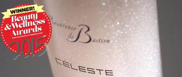 Close-up of a sparkling, shimmering beauty product container with the label "Révérence de Bastien CÉLESTE." A circular red sticker announces it as the winner of the Beauty & Wellness Awards 2015, with white and gold text.